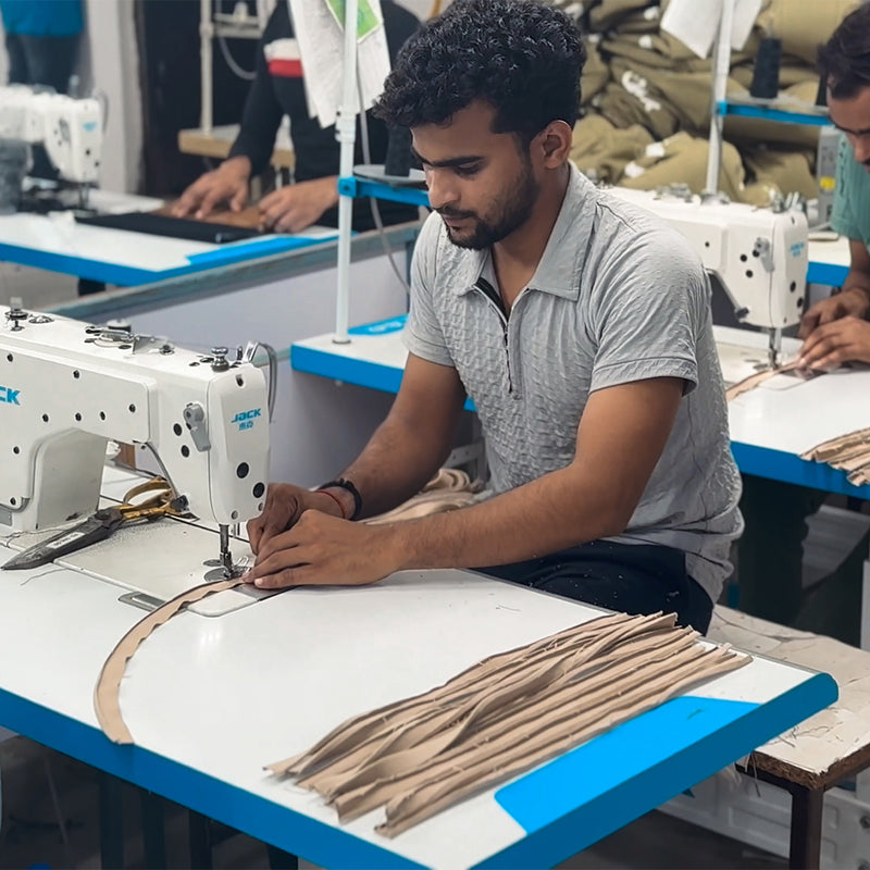 Meet the Hands Behind Your Bag_A look inside our factory in India, from the first cut to the final stitch_Each zip is hand-stitched into place before the panel comes together.